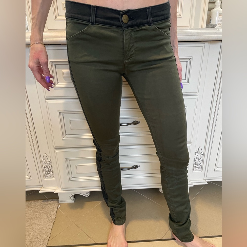 Green stretchy pants with black stripe down the side.